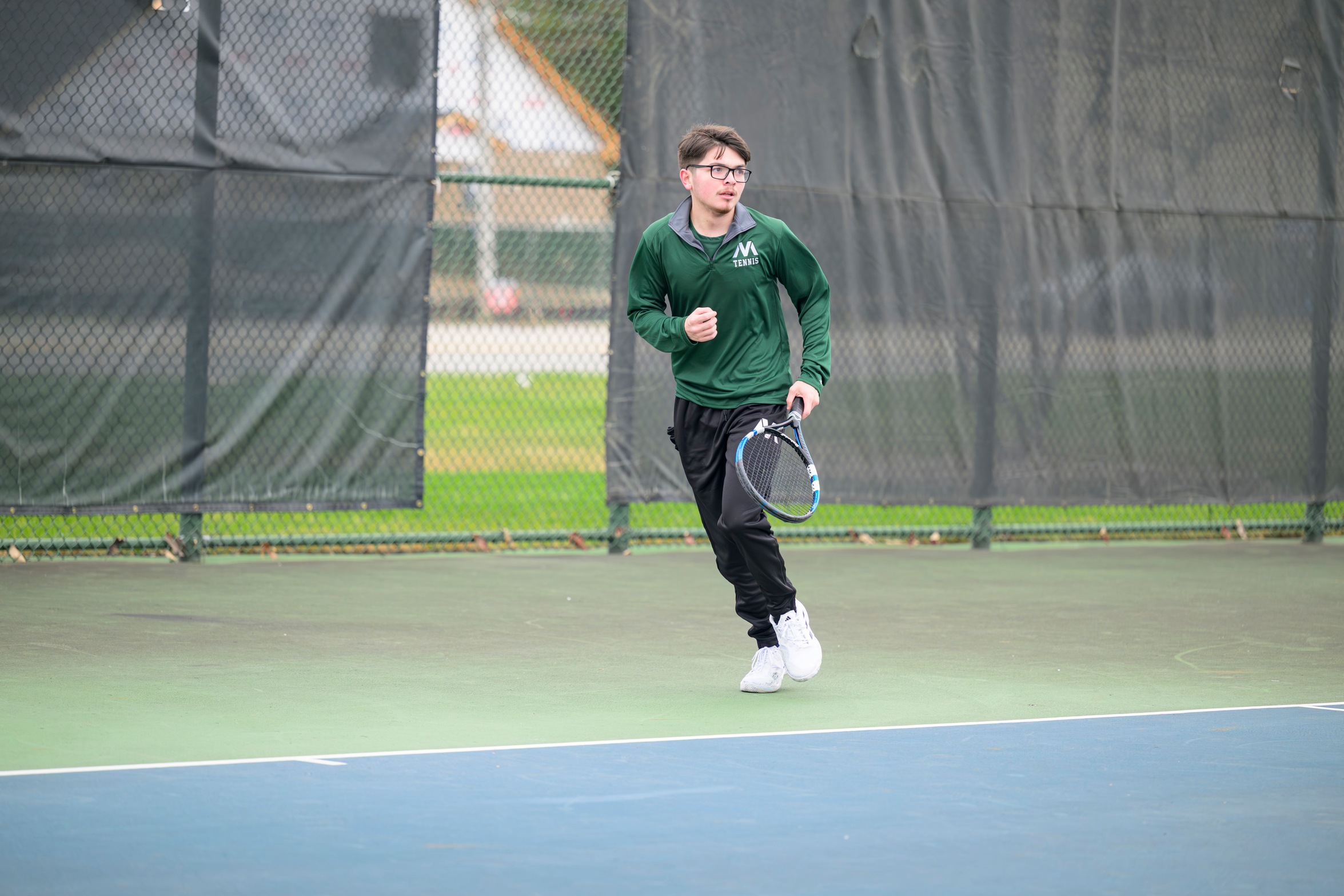 A Moraine Valley tennis player runs on the court.