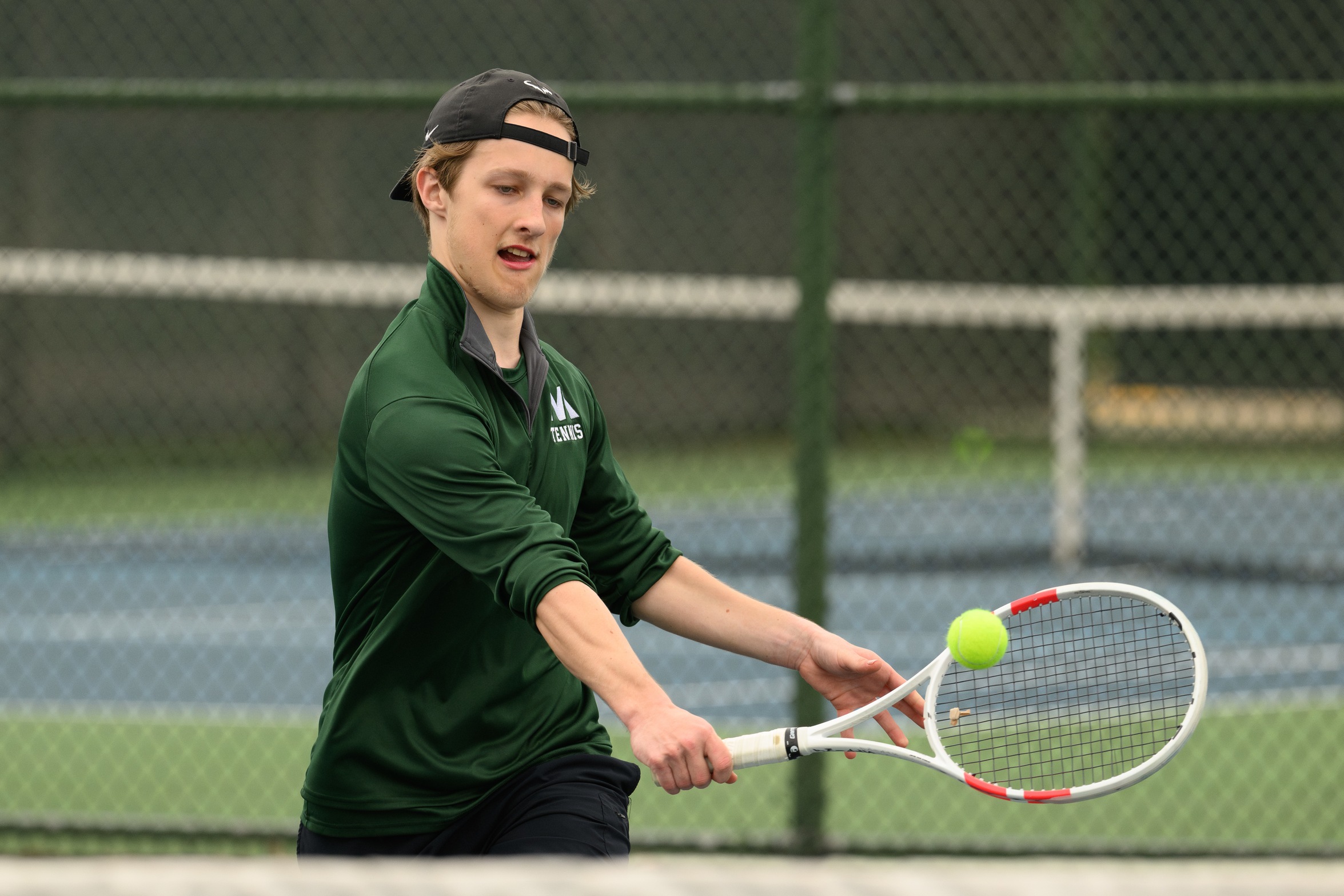 A Moraine Valley tennis player is about to hit the ball.