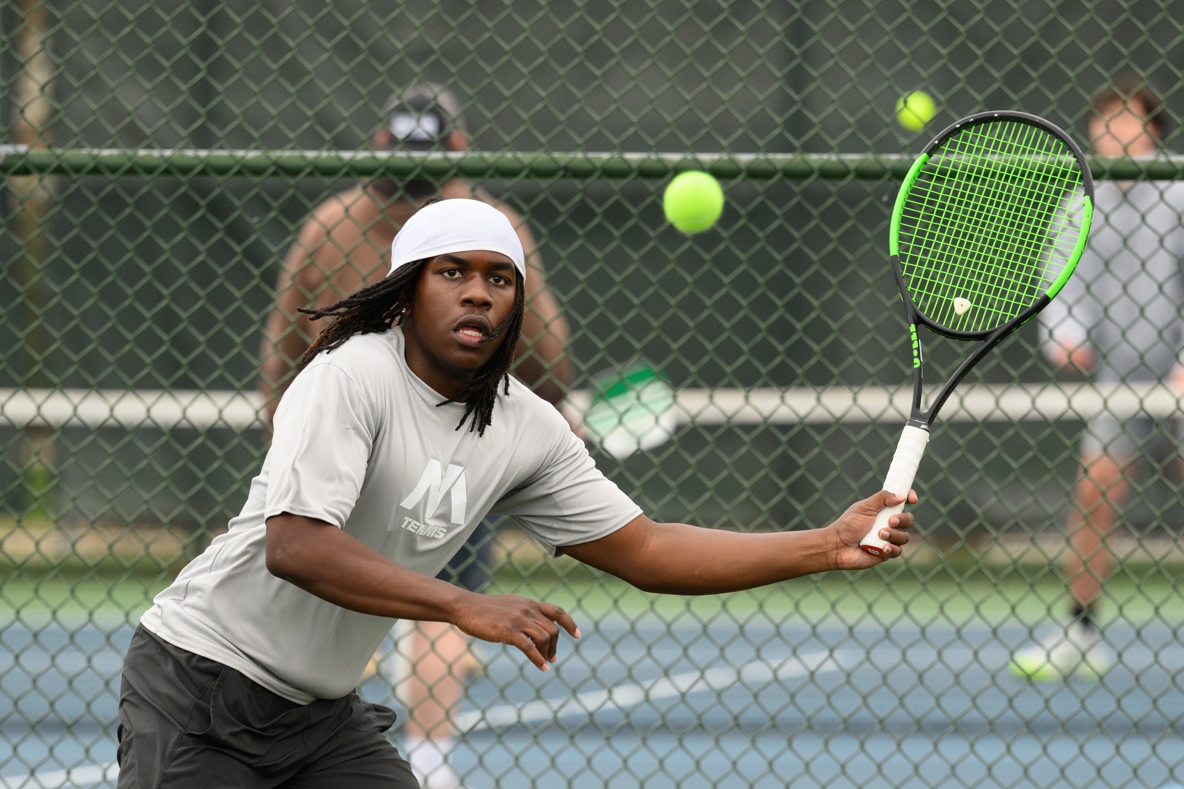 A tennis player hits the ball.