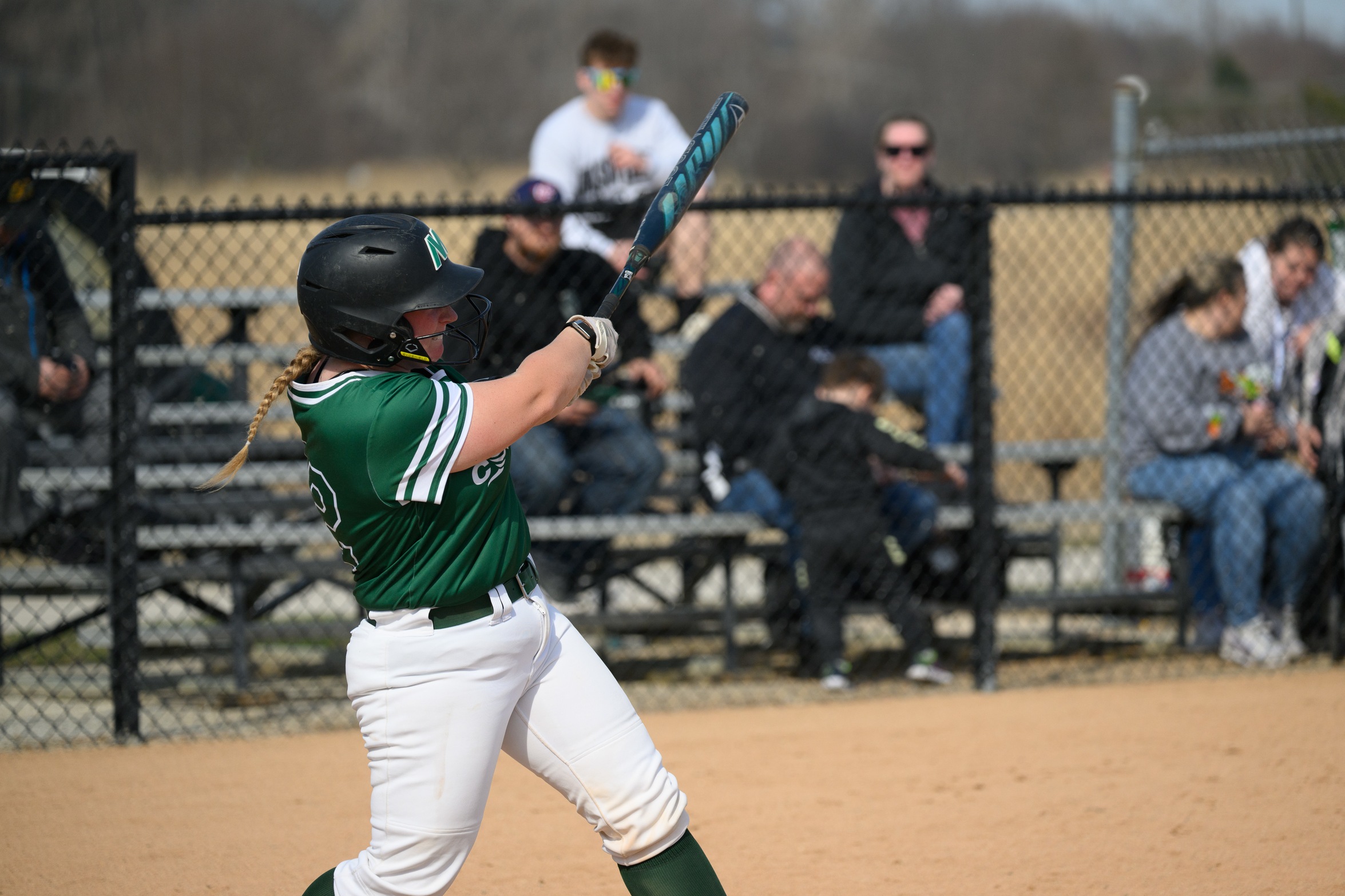 A Moraine Valley softball player swings at a pitch.