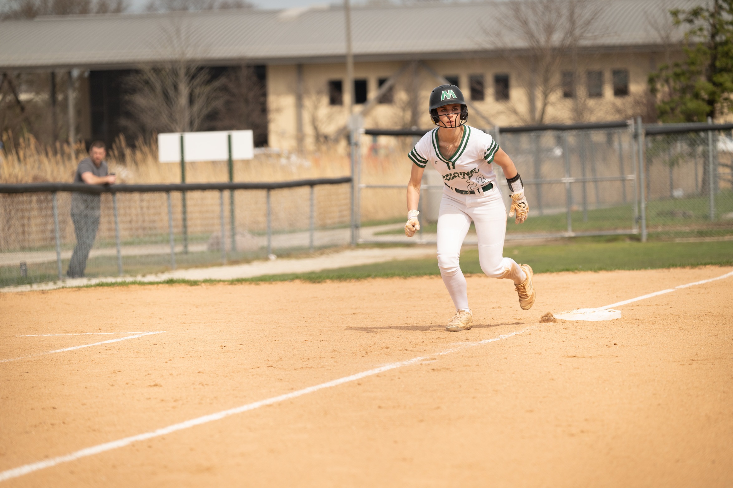 A Moraine Valley softball player runs from third base toward home plate.